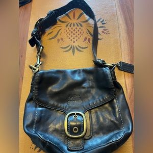 Beautiful COACH black leather purse with heavy brass and braided detailing.